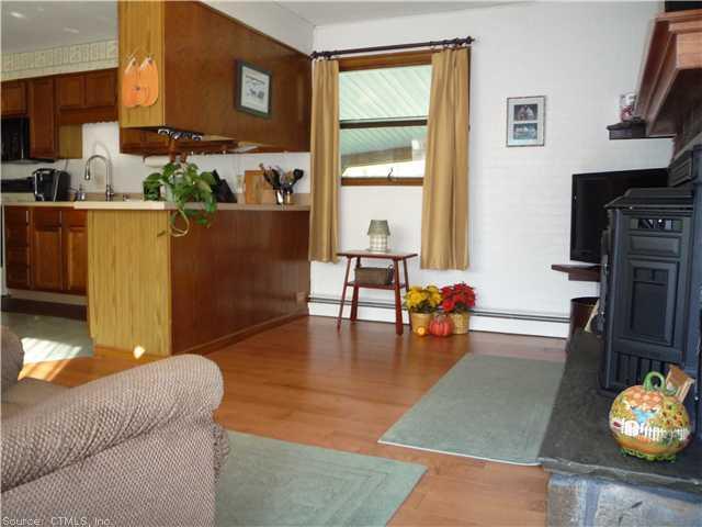 850 Suffield Street Suffield, CT 06078 - Photo 1 of 1 a living room with furniture and a fireplace