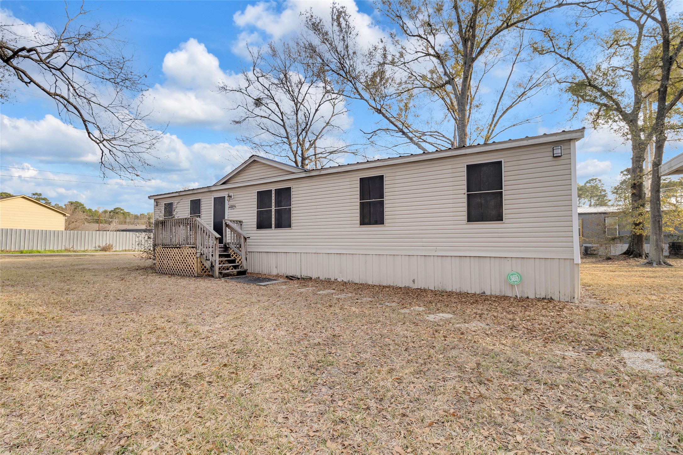 22094 Spear Road Porter, TX 77365 - Photo 2 of 45 The exterior is a light-colored siding. Generous yard space provides ample room for outdoor activities and relaxation.