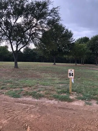 a view of outdoor space with field and trees