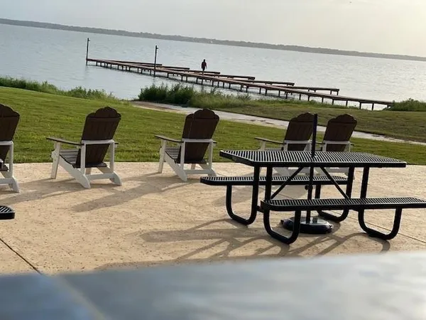 a view of a swimming pool with outdoor seating and lake