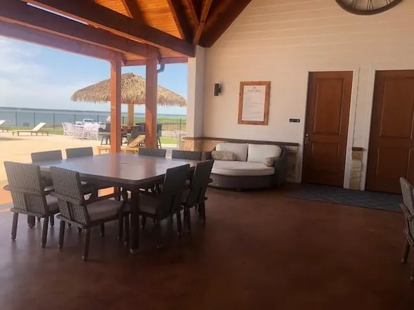 a dining room with furniture and a floor to ceiling window