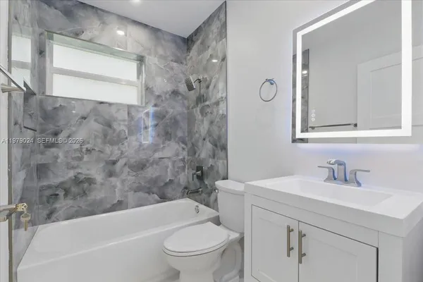 a bathroom with a sink a toilet and a bathtub