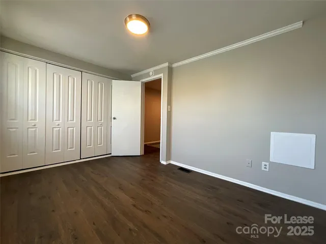 an empty room with wooden floor