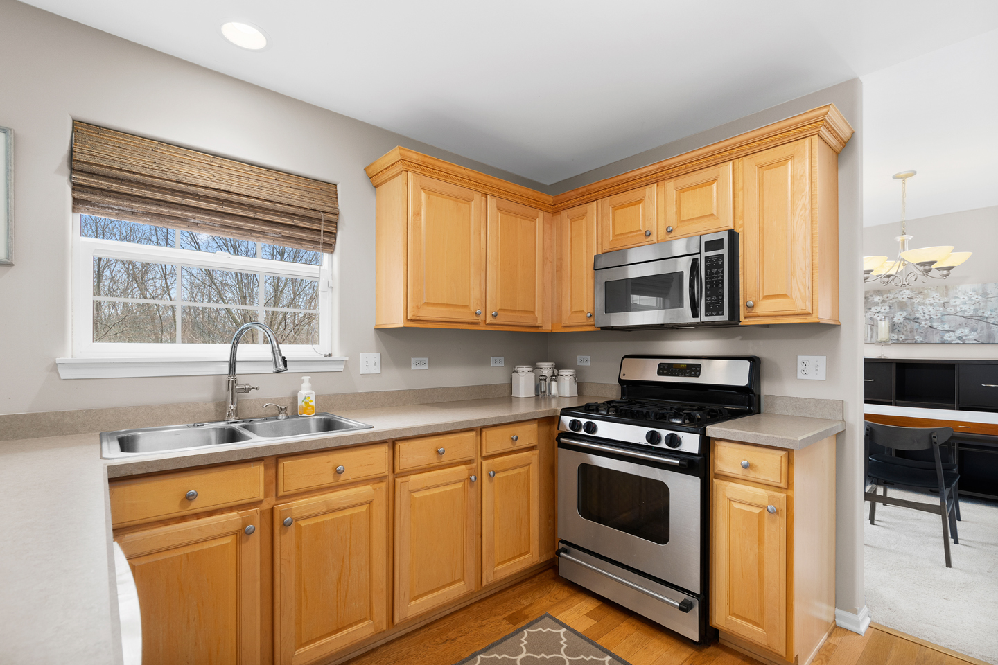 751 Sumac Drive Aurora, IL 60506 - Photo 11 of 33 a kitchen with stainless steel appliances a stove sink microwave and cabinets