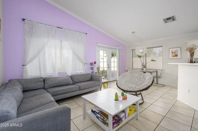 a living room with furniture a window and a dining table