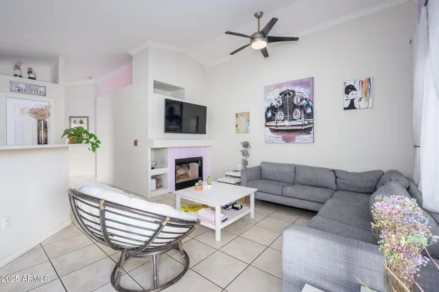a living room with furniture a fireplace and a flat screen tv