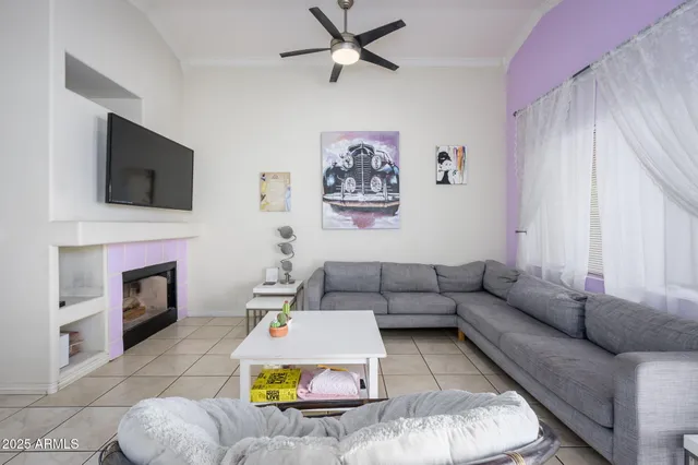 a living room with furniture a fireplace and a flat screen tv