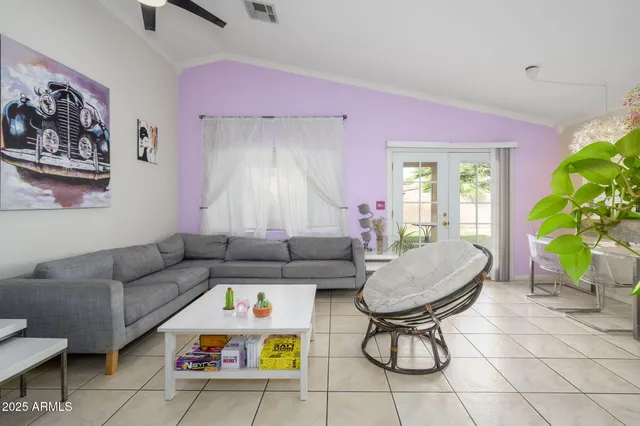 a living room with furniture and a potted plant