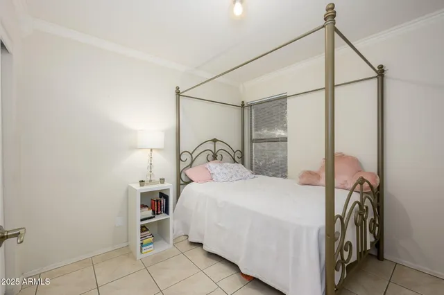 a bedroom with a bed and a mirror