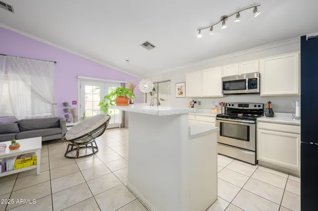 a kitchen with a stove a sink and a refrigerator