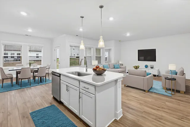 a kitchen with stainless steel appliances granite countertop a sink stove and wooden floor