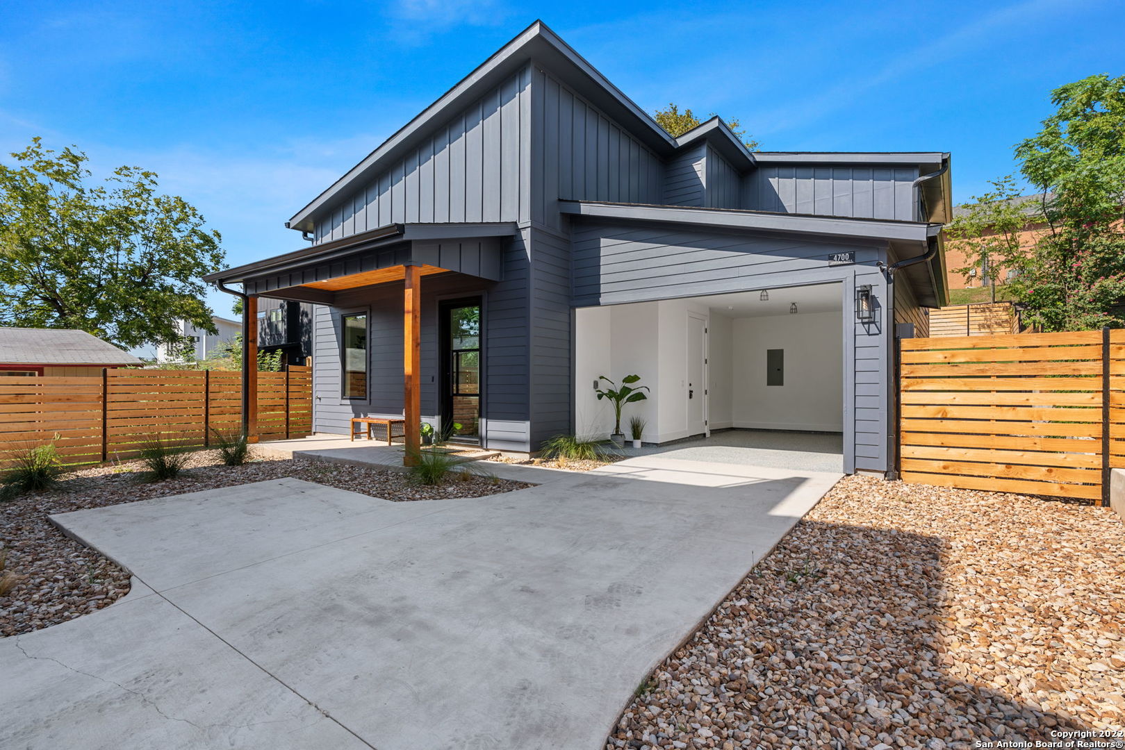 a view of a house with wooden fence