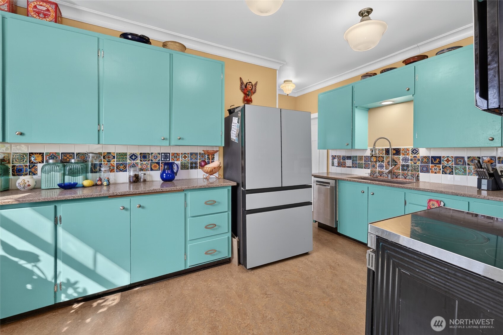 237 West 3rd Street Port Angeles, WA 98362 - Photo 15 of 40 a kitchen with sink cabinets and wooden furniture