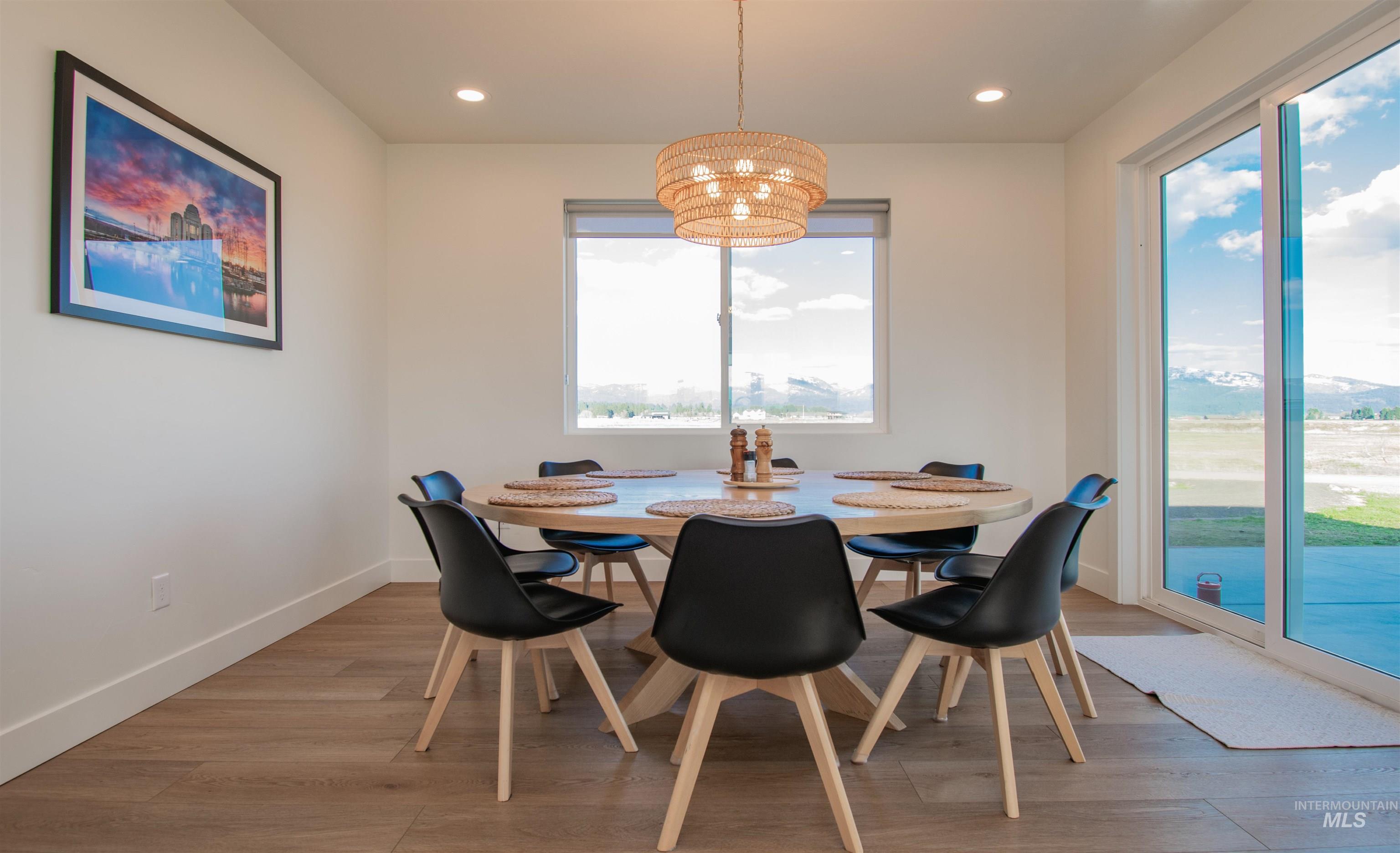 44 Big Moose Road McCall, ID 83638 - Photo 11 of 50 Dining area featuring wood-finish flooring and a contemporary woven pendant light fixture