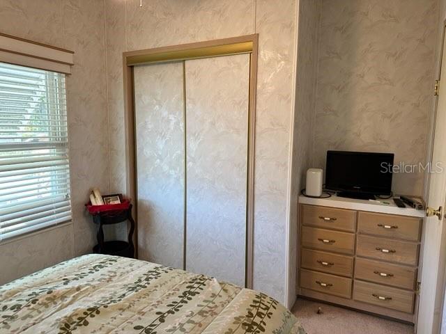 359 Pine Loop Frostproof, FL 33843 - Photo 15 of 31 a bedroom with a bed and a flat screen tv