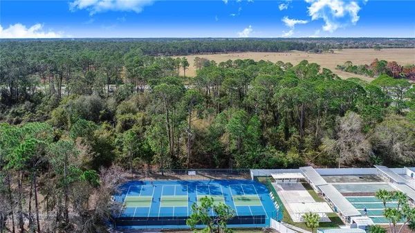 an aerial view of residential houses with outdoor space and lake view