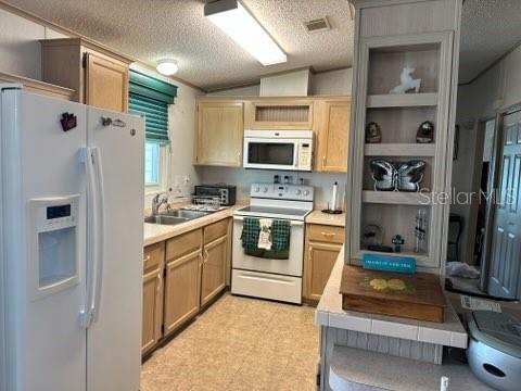 359 Pine Loop Frostproof, FL 33843 - Photo 9 of 31 a kitchen with stainless steel appliances a refrigerator sink and cabinets