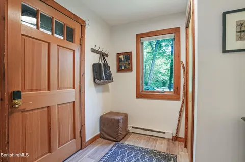 a view of room with window and wooden floor