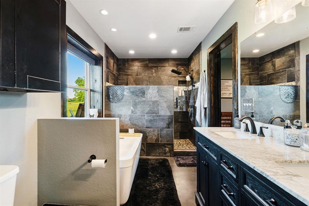 962 County Road Pattonville, TX 75468 - Photo 21 of 37 a bathroom with a double vanity sink and a mirror