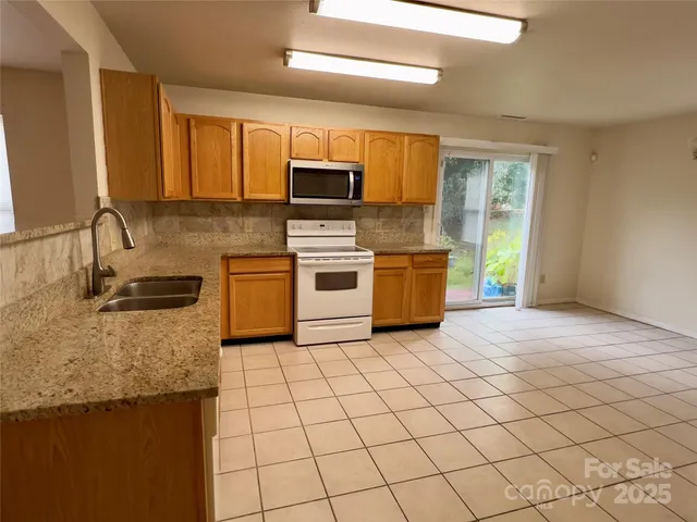 a view of a kitchen with microwave and cabinets