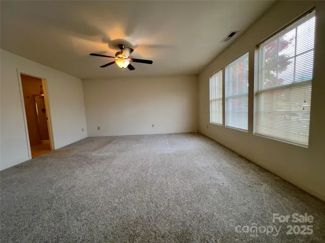 a view of a room with window and a ceiling fan
