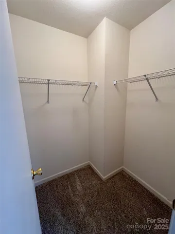 a white car parked in front of a white house