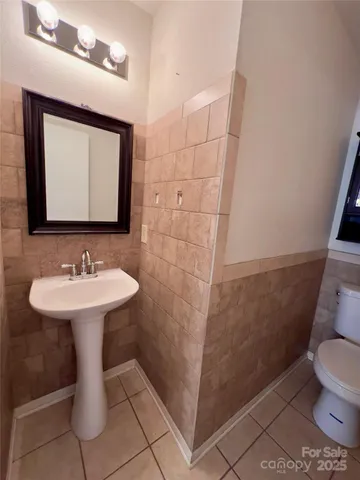 a bathroom with a sink toilet and mirror