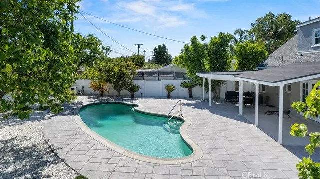 a view of a house with backyard sitting area and garden