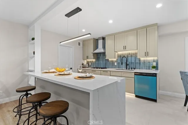 a kitchen with a sink cabinets and stove