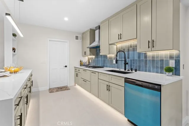 a kitchen with a sink a stove and cabinets
