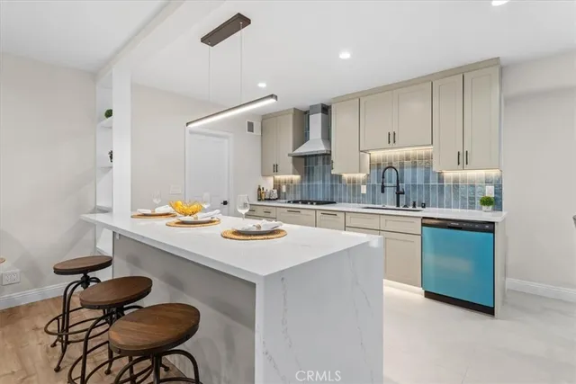 a kitchen with a sink and chairs
