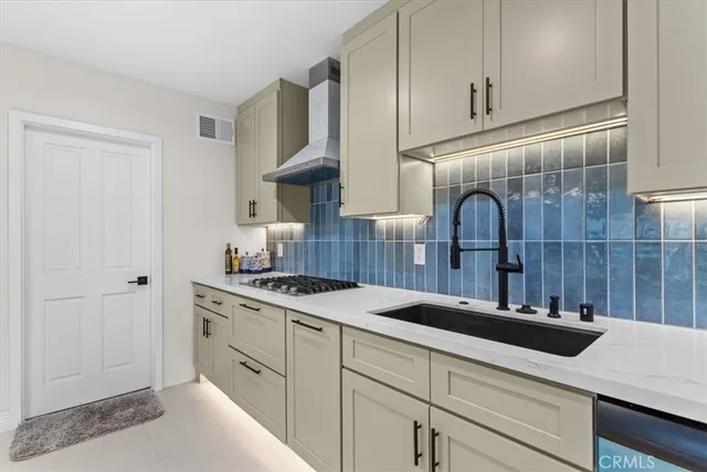 a kitchen with a sink and cabinets