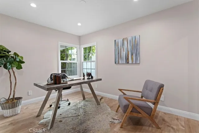 a view of a workspace with furniture and a potted plant