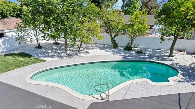 an aerial view of a house with a yard and plants