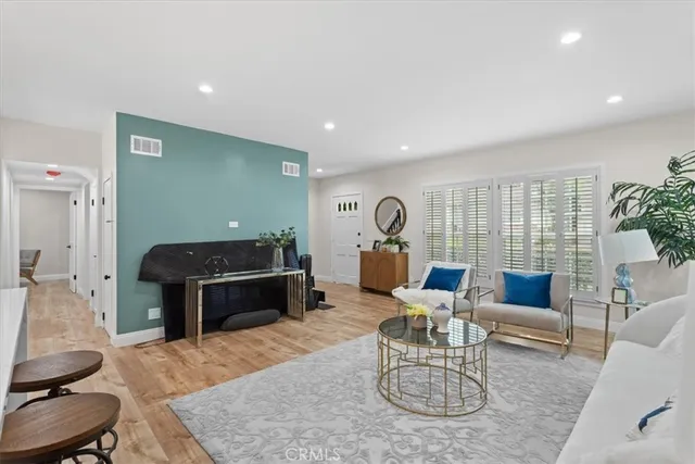a living room with furniture a rug and a large window