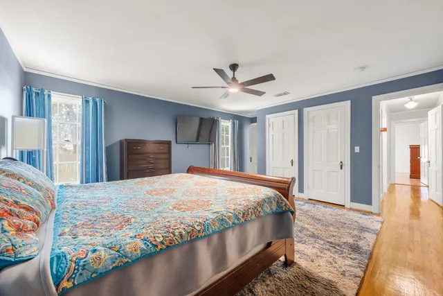 a bedroom with a large bed and a chandelier