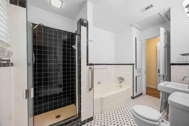 a bathroom with a shower a toilet and a sink