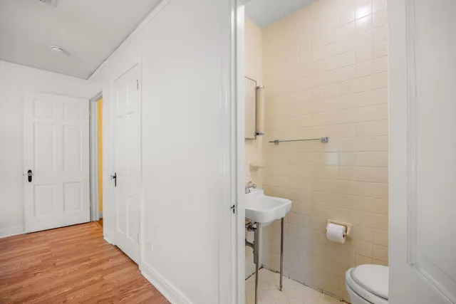 a bathroom with a toilet and a shower
