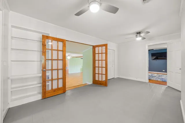 an empty room with windows and closet