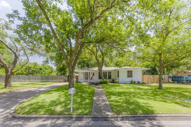 a view of a house with a yard porch and sitting area