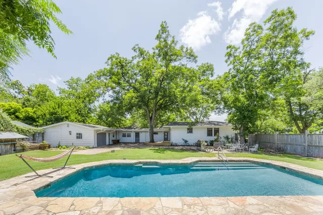 a view of a swimming pool with an outdoor seating and yard