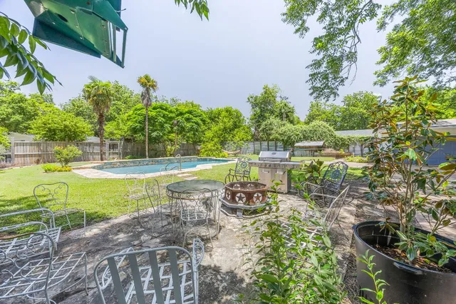 a view of a swimming pool with a patio
