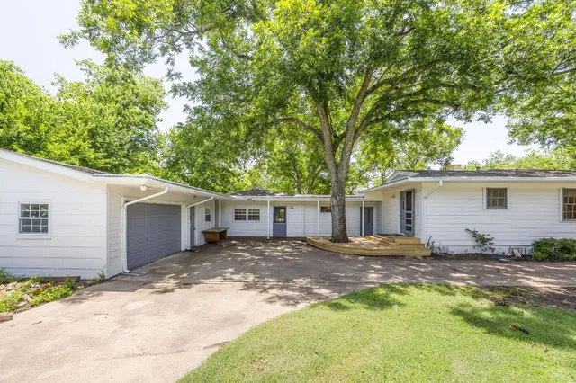 a view of a house with a yard and garage