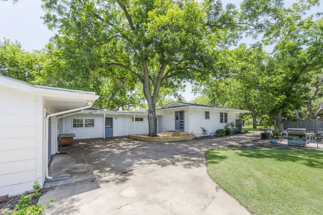 a backyard of a house with yard and outdoor seating