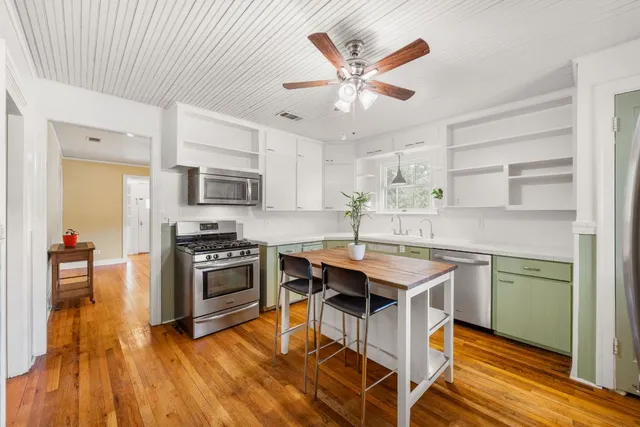 a kitchen with a sink appliances and cabinets