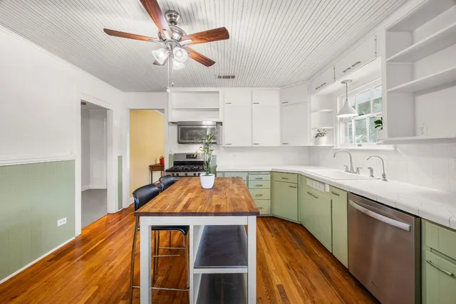 a kitchen with stainless steel appliances granite countertop a sink dishwasher stove and refrigerator