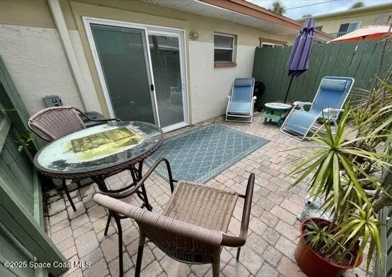 a backyard of a house with table and chairs