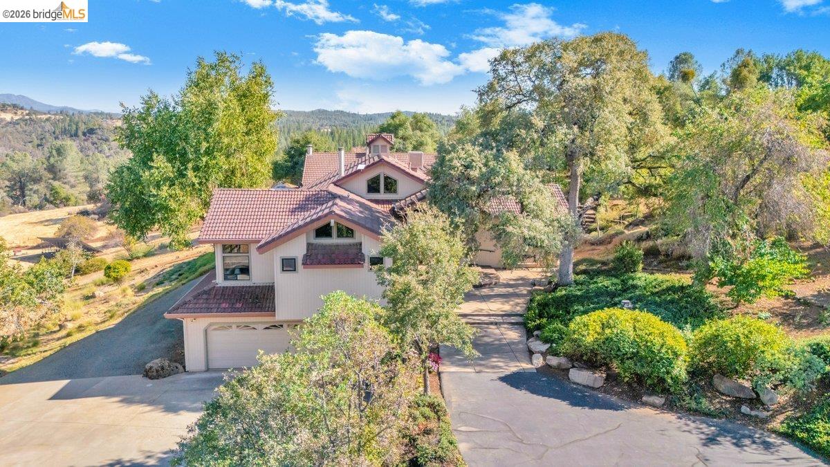 13700 Clements Road Groveland, CA 95321 - Photo 67 of 93 View of front of property with a garage, a tile roof, stucco siding, driveway, and a mountain view