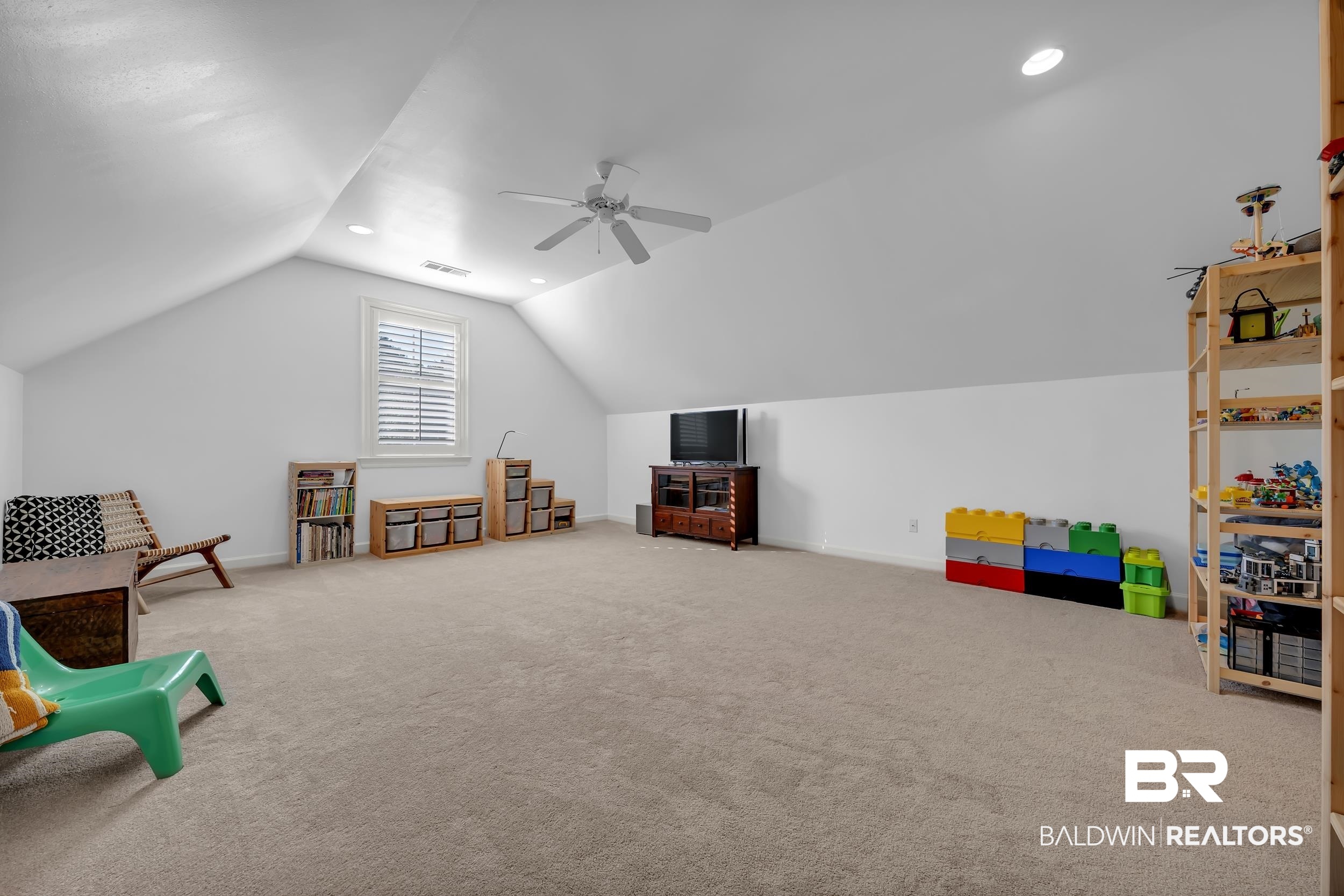 8137 Pine Run Daphne, AL 36527 - Photo 38 of 67 Spacious bonus room featuring vaulted ceilings, recessed lighting, neutral carpeting, a ceiling fan, and a window with plantation shutters