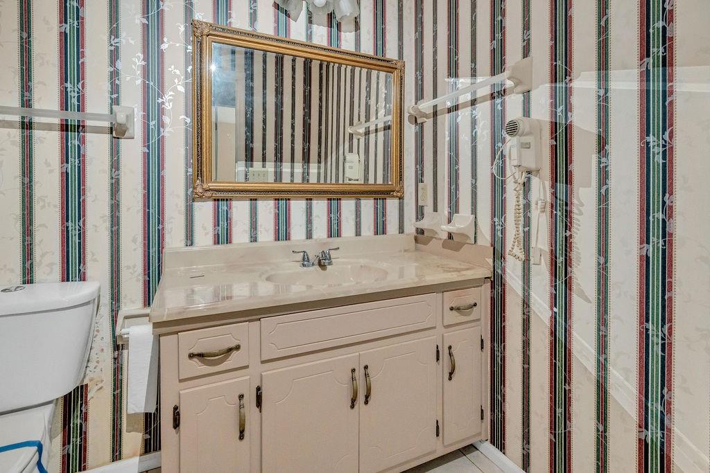 5800 Yellow Creek Road Murrayville, GA 30564 - Photo 17 of 33 a bathroom with a granite countertop sink and a mirror